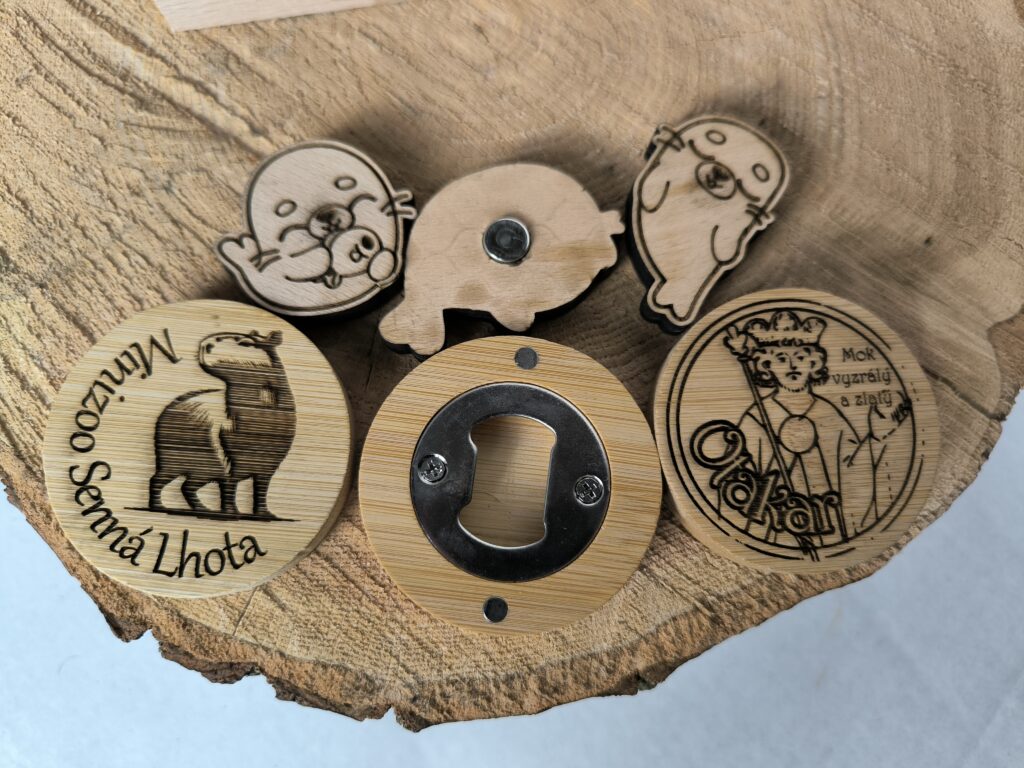assortment of wooden products, mainly bottle openers and magnets
