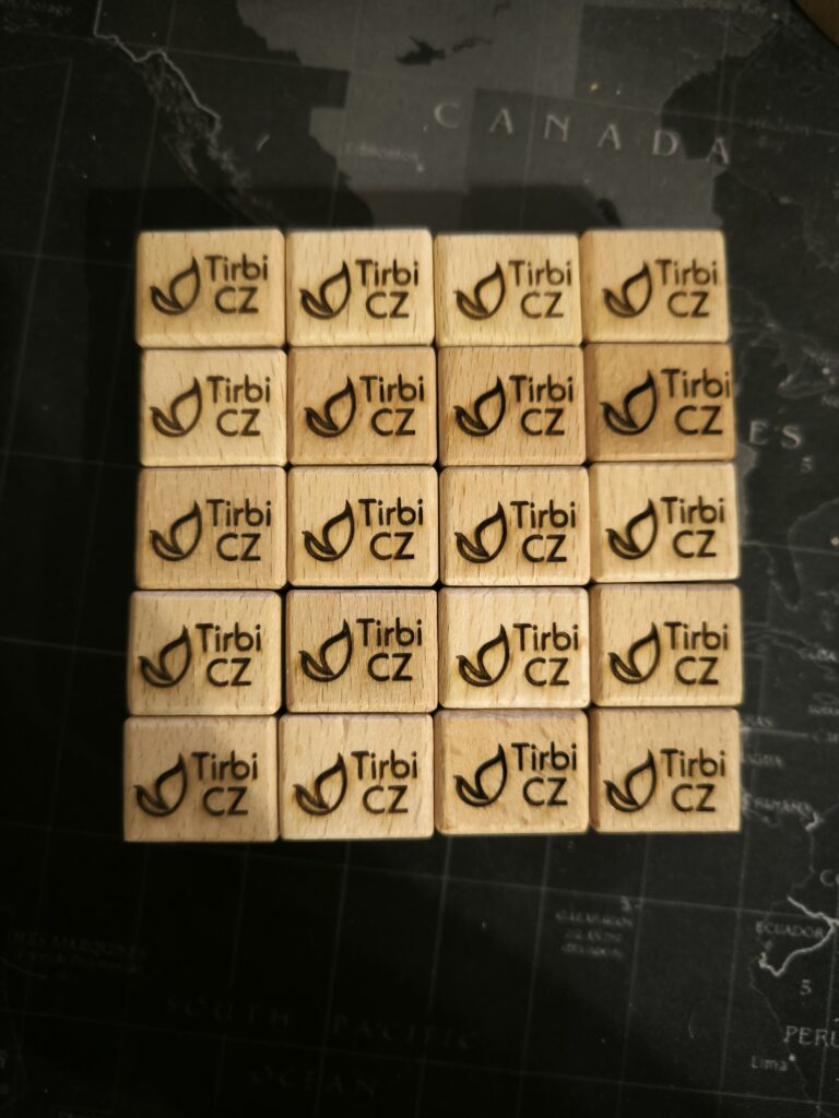 small wooden cubes with engraved logo reading Tirbi.cz