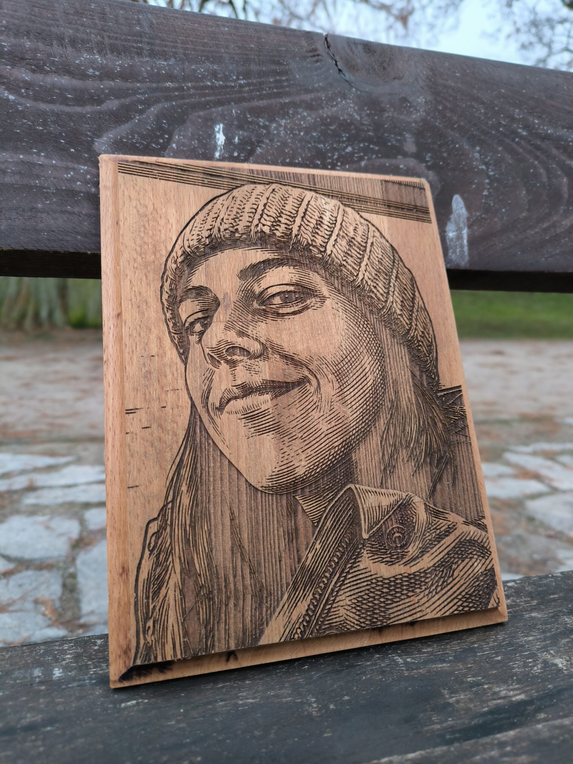 wooden portrait of a young woman wearing a winter hat